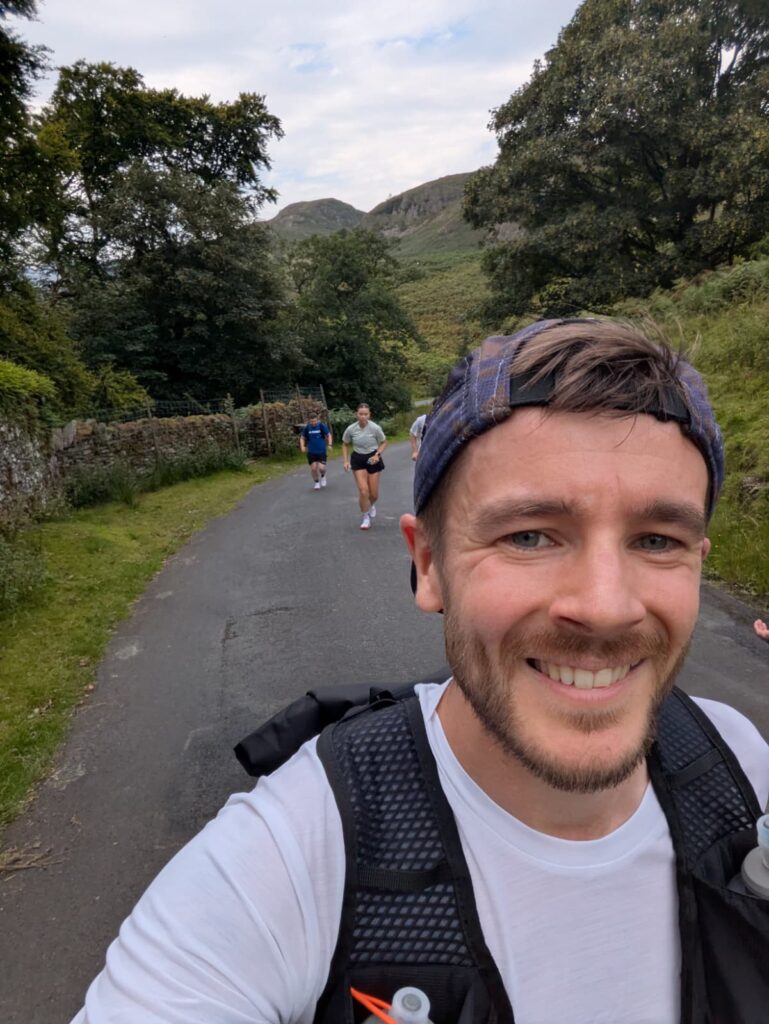 person running through countryside at an event with other runners