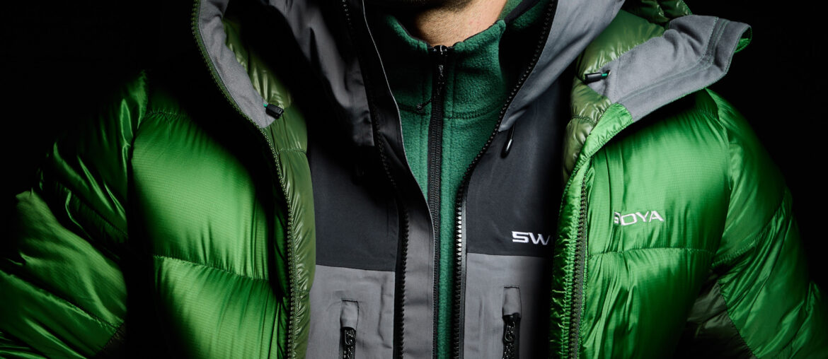 model wearing swoya down jacket, waterproof jacket, and fleece