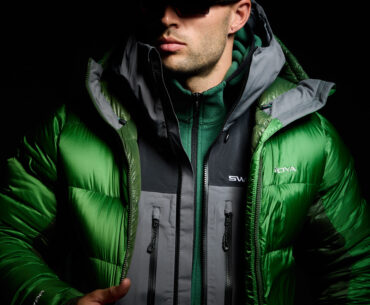model wearing swoya down jacket, waterproof jacket, and fleece