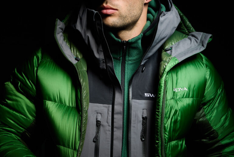model wearing swoya down jacket, waterproof jacket, and fleece